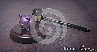 Piggy bank lying on sounding block with gavel beside. Stock Photo