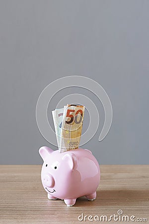 Piggy bank or piggybank filled with euro bills Stock Photo