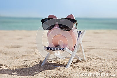 Piggy bank with sunglasses Stock Photo