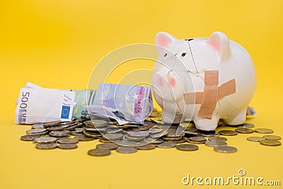 The piggy bank was broken in a difficult period of life. She saved during the crisis, accumulated a lot of coins and Stock Photo