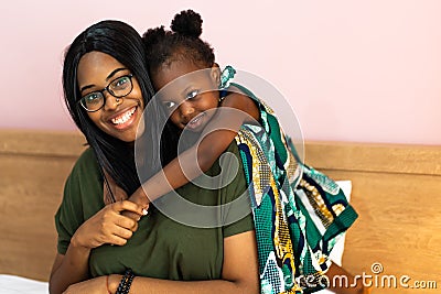 Piggyback ride with mum. Cute afican american daughter on a piggy back ride with her mother Stock Photo