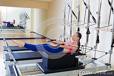 Pilates reformer woman back stroke exercise Stock Photo