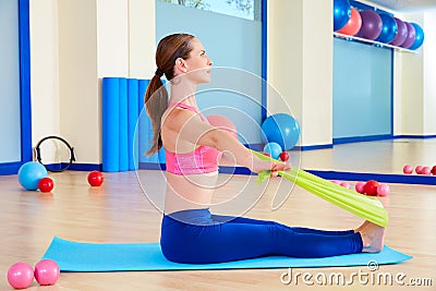 Pilates woman rowing rubber band exercise Stock Photo