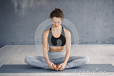 Girl sitting in butterfly position with bare feet Stock Photo