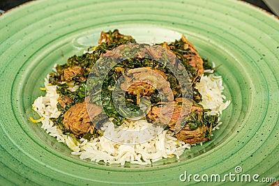 Pilau on Green Plate, Beef Pilaf, Traditional Asian Dish Plov also known as Polow, Pilav, Pallao, Pulao, Palaw Stock Photo