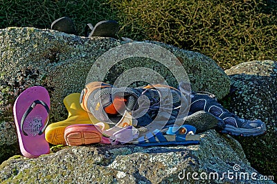 A pile of abandoned or lost shoes and assorted footwear Stock Photo