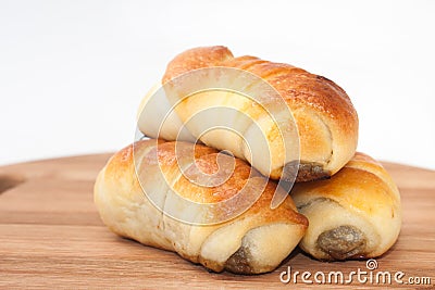 Pile of baked rolls stuffed with minced meat Stock Photo