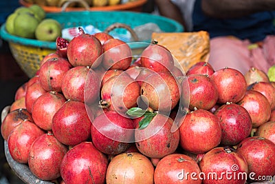 A pile of beautiful organic burgundy pomegranates Stock Photo