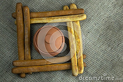A pile of breadsticks or grissini in the shape of a square, inside ajar Stock Photo