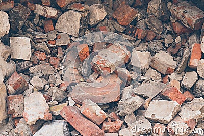 Pile of broken bricks, background. Texture, pattern, brick wall collapse. Destruction surface of building`s facade. Debris. Stock Photo