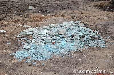 A pile of broken pieces of glass on the ground Stock Photo