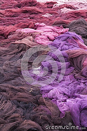 Pile of brown, violet and pink fishing nets Stock Photo