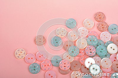 Pile of candy button for sewing on pink background Stock Photo