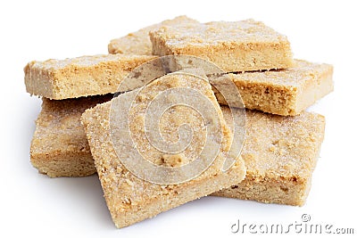 Pile of classic homemade square shortbread biscuits isolated on Stock Photo