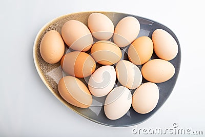 Pile of colored chicken eggs on plate isolated on white background. top view, close up Stock Photo
