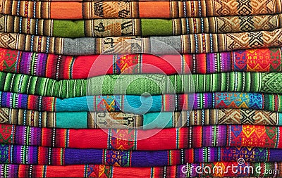 A pile of colorful Andean textiles photographed in the local handicraft market of Cusco Stock Photo