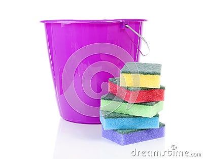 Pile of colorful sponge scourer and pink bucket over white background Stock Photo