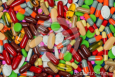 Pile of colorful tablets and capsule pills. Full frame of medicine, vitamins and supplements. Top view many of pills background. Stock Photo