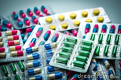 Pile of colorful tablets and capsules pills in blister packs. Global health care and drug use with reasonable concept Stock Photo