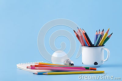 Pile of colour pencils on light blue background, creative idea c Stock Photo