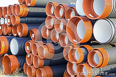 Pile of corrugated PVC sewer or drain pipes Stock Photo