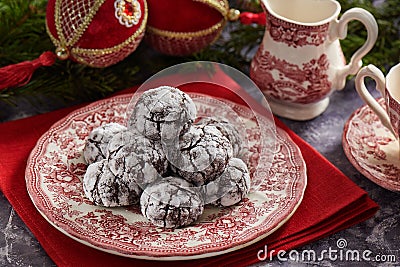 Pile of cracked chocolate cookies on old english style plate, Christmas decoration on background Stock Photo