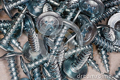 Pile of cross recessed sheetmetal screws, zinc plated, close-up Stock Photo
