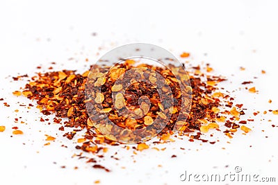 Pile crushed red cayenne pepper, dried chili flakes and seeds isolated on white background Stock Photo