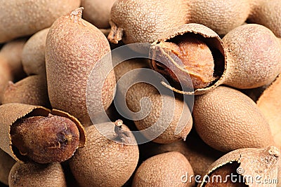 Pile of delicious ripe tamarinds as background, closeup Stock Photo