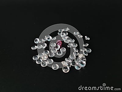 Pile of diamonds lying down at black textile shining Stock Photo