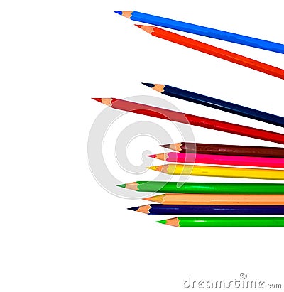 Pile of different colored wood pencil crayons placed on a white paper background Stock Photo