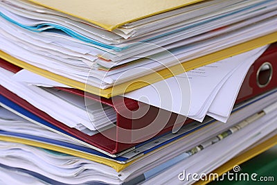 Pile of different file folders or ring binders full with office documents Stock Photo