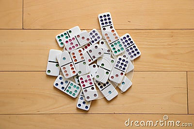 Pile of Dominoes on Wooden Floor Stock Photo