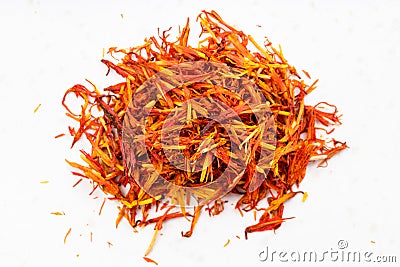 Pile of dried safflower petals close up on gray Stock Photo