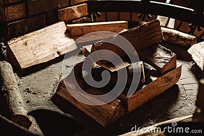 A pile of firewood in the fireplace is ready to be set on fire. Warm hearth Stock Photo