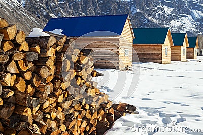Pile of firewood stacked up in front of a houses. Rural scene Stock Photo
