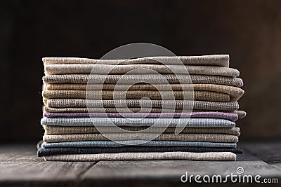 A pile of four folded dull-colored natural linen fabric Stock Photo