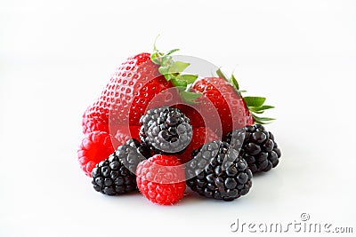 Pile of fresh berries on a white background including strawberries, blackberries and raspberries Stock Photo