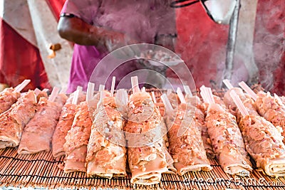 Pile of fresh Hashimaki Japanese pancake on a chopstick from Hiroshima Stock Photo