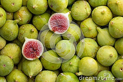 Pile of fresh, honey sweet, green figs, one cut open Stock Photo