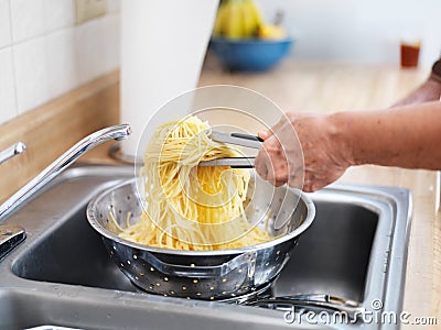 Pile of fresh pasta in strainer Stock Photo