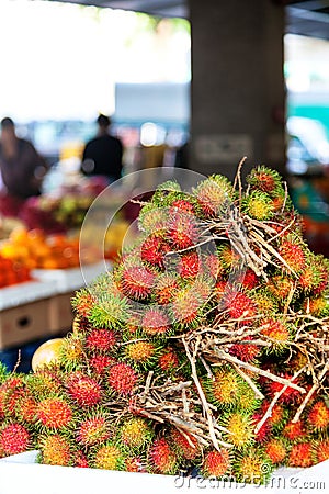Pile of fresh Rambutan on sale in a fruit market Stock Photo