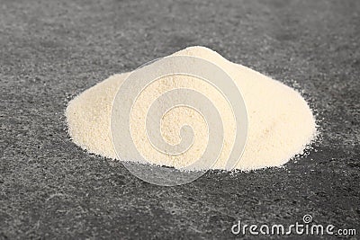 Pile of fresh semolina on grey table Stock Photo