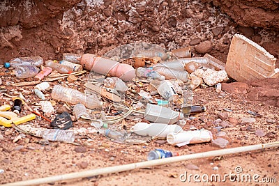 a pile of garbage on the ground next to some rocks Stock Photo