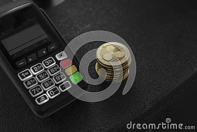 A pile of gold Ripple Crypto currency coins and POS terminal. Ripples Cryptocurrency. E-commerce, business, finance Editorial Stock Photo