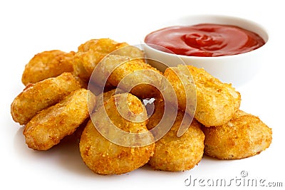 Pile of golden deep-fried battered chicken nuggets with bowl of Stock Photo