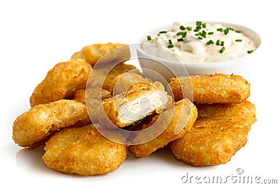 Pile of golden deep-fried battered chicken nuggets with bowl of Stock Photo