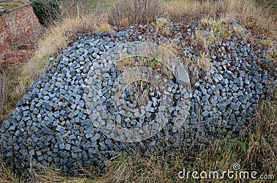 A pile of granite cubes overgrown with grass. it is a natural and at the same time anthropic habitat for lizards, snakes and insec Stock Photo