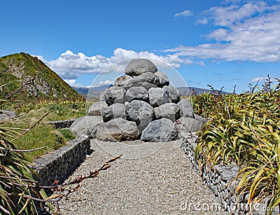 The pile of grey boulders near Tarakena Bay, North Island, New Zealand was built as a reminder of the point thar raw sewage used Stock Photo