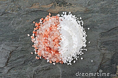 Pile of half pink Himalayan and half sea salt, above on a dark background. Stock Photo